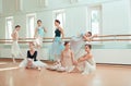 The seven ballerinas at ballet bar