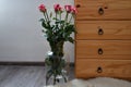 Seven bouquets of roses in a vase built with wooden dressers. Royalty Free Stock Photo