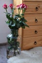 Seven bouquets of roses in a vase built with wooden dressers Royalty Free Stock Photo