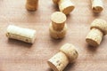 Seven caps of cork champagne randomly scattered on a wooden board Royalty Free Stock Photo