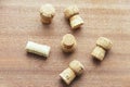 Seven caps of cork champagne randomly scattered on a wooden board Royalty Free Stock Photo