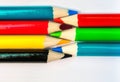 Seven colored pencils. The colors red, green, blue, cyan, magenta, yellow and black. Concept of color profiles converting from RGB Royalty Free Stock Photo