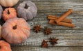 Seven rustic aged pumpkins different colors on a rustic wooden background.