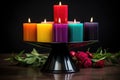seven colorful candles in a black candle holder Royalty Free Stock Photo