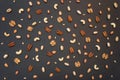 Seven different nuts on a black background pattern Royalty Free Stock Photo