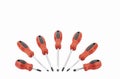 Seven different screwdrivers with red handles