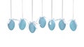 Seven Easter blue eggs hanging on ribbons a small bow isolated on a white background. Royalty Free Stock Photo