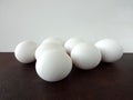 Seven Eggs on a Brown Counter against a White Background