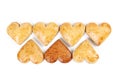 Seven gingerbread hearts in two rows on white background