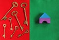 seven golden keys in different direction on red felt and toy hou Royalty Free Stock Photo