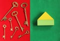 Seven golden keys in different direction on red felt and house o Royalty Free Stock Photo