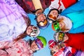 Seven happy friends in circle wearing goggles