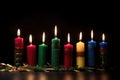 the seven kwanzaa candles glowing against dark backdrop