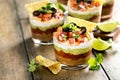 Seven layer dip in individual cups, mexican appetizer