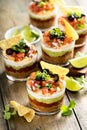 Seven layer dip in individual cups, mexican appetizer