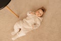 Seven month girl is lying on the carpet Royalty Free Stock Photo