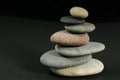 Seven pebbles pyramid over dark Royalty Free Stock Photo