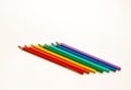 Seven pencils of different colors on a white background Royalty Free Stock Photo