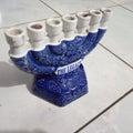 seven-pronged candle holder in blue and white with a white floor