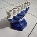 seven-pronged candle holder in blue and white with a white floor