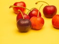 Seven red cherries on yellow background. Royalty Free Stock Photo