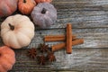 Seven rustic aged pumpkins different colors on a rustic wooden background.