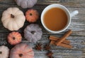 Seven rustic aged pumpkins different colors on a rustic wooden background.