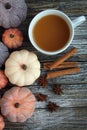 Seven rustic aged pumpkins different colors on a rustic wooden background.