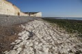 Seven Sisters and Beachy Head cliffs, England - chalk rocks on the beach and blue skies. Royalty Free Stock Photo