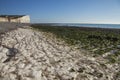 Seven Sisters and Beachy Head cliffs, England, the UK - chalk rocks on the beach and blue skies. Royalty Free Stock Photo