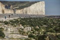 Seven Sisters, East Sussex, England, the UK; white beach, green seaweeds and tpurists. Royalty Free Stock Photo