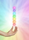 Seven Spinning Chakras on Rainbow colored background