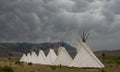 Seven Teepees Fill The Frame Below Storm Clouds Royalty Free Stock Photo