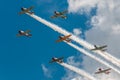 Seven AT-6 Texans With Smoke Trails and Clouds