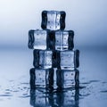 Of seven transparent ice cubes, arranged in a pyramid on a reflective Royalty Free Stock Photo