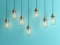 Seven vintage lamps hanging from the ceiling with blue wall 3D renderind