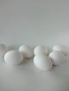 Seven White Eggs against a White Background