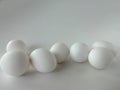 Seven White Eggs in a White Bowl against a White Background