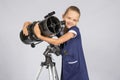 Seven-year girl hugging her given reflector telescope