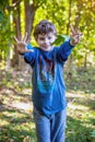 Seven year old birthday boy holding out seven fingers