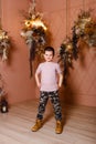 Seven-year-old boy in brown shoes stands tall and looks into the camera Royalty Free Stock Photo