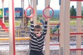 Seven-year-old boy hangs on the gymnastic rings on the Playground.