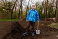 Seven-year-old boy with a shovel in the garden
