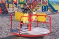 Seven-year-old boy spinning on the carousel on the Playground. Royalty Free Stock Photo