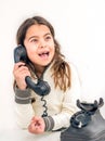 Seven year old girl with old vintage phone before white background Royalty Free Stock Photo