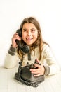 Seven year old girl with old vintage phone before white background Royalty Free Stock Photo