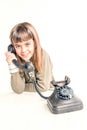 Seven year old girl with old vintage phone before white background Royalty Free Stock Photo