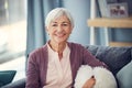 Seventy is the new fifty. Cropped portrait of a happy senior woman relaxing comfortably on her couch at home. Royalty Free Stock Photo