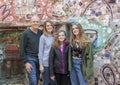 Seventy year old male posing with his daughter and two granddaughters in the Magic Garden of Isaiah Zagar, Philadelphia