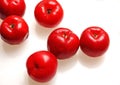 Several acerola fruit on white foreground